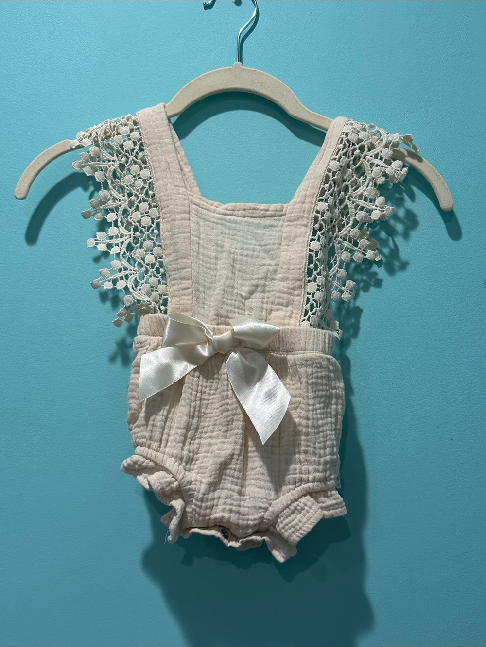 Delicate Cream Baby One-Piece Romper with Lace Straps and Satin Bow